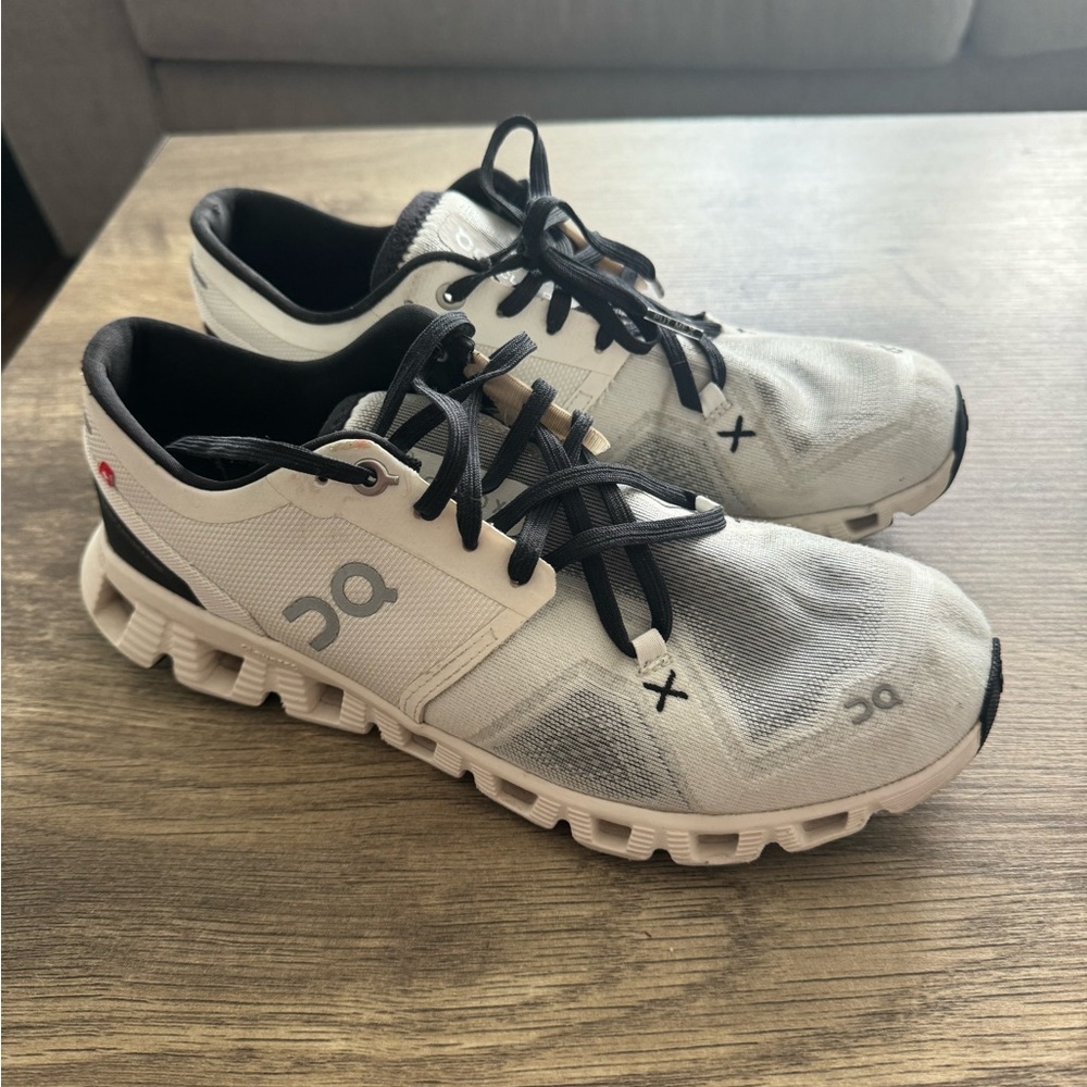 On Running White and Black Athletic Shoes with Cloud Pods